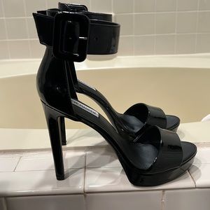 NWT black patent leather platform style w/ ankle strap.